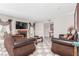 Spacious living room with fireplace and tiled floors, featuring neutral decor and natural light at 2645 Heritage Ct, Las Vegas, NV 89121