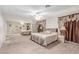 Main bedroom featuring a mirrored closet, ceiling fan, and plush carpeting at 2645 Heritage Ct, Las Vegas, NV 89121
