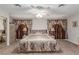 Spacious main bedroom with a ceiling fan, plush carpeting, and elegant curtains at 2645 Heritage Ct, Las Vegas, NV 89121
