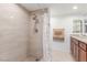 Shower featuring tiled walls, shower head, decorative shower curtain, tile floors and modern vanity at 2645 Heritage Ct, Las Vegas, NV 89121