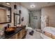 A modern bath with a vessel sink, soaking tub, and spacious walk-in shower at 2649 Golden Sands Dr, Las Vegas, NV 89128