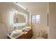 Bright bathroom boasts double sinks, wood cabinets, a large mirror, and modern lighting fixtures at 2649 Golden Sands Dr, Las Vegas, NV 89128