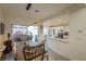 Dining area with a rustic wooden table and modern light fixture, connecting to the kitchen at 2649 Golden Sands Dr, Las Vegas, NV 89128