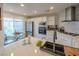 Bright modern kitchen with stainless appliances, white cabinets, marble backsplash, and breakfast nook at 2649 Golden Sands Dr, Las Vegas, NV 89128