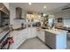 Bright, modern kitchen featuring stainless steel appliances, white cabinets, marble backsplash, and dining area at 2649 Golden Sands Dr, Las Vegas, NV 89128