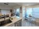 Bright, modern kitchen with stainless steel appliances, white cabinets, marble backsplash, and seating area at 2649 Golden Sands Dr, Las Vegas, NV 89128