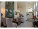 An open-concept living room with high ceilings, a fireplace, and staircase to the second floor at 2649 Golden Sands Dr, Las Vegas, NV 89128