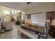 Bright living room with rustic dining table and view of staircase and front door at 2649 Golden Sands Dr, Las Vegas, NV 89128