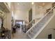 View of a living room from the staircase, featuring high ceilings and a fireplace at 2649 Golden Sands Dr, Las Vegas, NV 89128