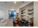 Upper level loft with custom shelving, a large desk, and a view to another room at 2649 Golden Sands Dr, Las Vegas, NV 89128