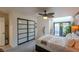 Bright primary bedroom with wood accent wall, unique ceiling fan and door to backyard at 2649 Golden Sands Dr, Las Vegas, NV 89128