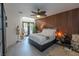 Airy primary bedroom with wood accent wall, unique ceiling fan and light, and access to the backyard at 2649 Golden Sands Dr, Las Vegas, NV 89128