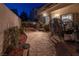 Serene backyard patio with stone pavers, comfortable seating, and ambient lighting for evening enjoyment at 2649 Golden Sands Dr, Las Vegas, NV 89128
