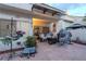 Cozy backyard patio with stone pavers, comfortable seating, and a covered area for entertaining at 2649 Golden Sands Dr, Las Vegas, NV 89128