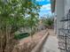 Side yard with defined planter and path and view to backyard patio seating area at 2761 Phoenix St, Las Vegas, NV 89121