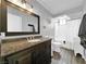 Bathroom features a sleek vanity with a dark countertop and a shower-tub combo with tiled floors at 2761 Phoenix St, Las Vegas, NV 89121
