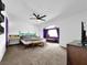 Large bedroom features a ceiling fan, sitting area, a vanity, and carpet floors at 2761 Phoenix St, Las Vegas, NV 89121