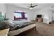 Bedroom with carpeted floors, a ceiling fan, and a sitting area next to the window at 2761 Phoenix St, Las Vegas, NV 89121