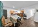Open concept dining room with brick fireplace, wood floors, and kitchen access at 2761 Phoenix St, Las Vegas, NV 89121