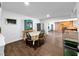 A dining room features wood floors, a hutch, stainless steel fridge, a wood table, and an open archway at 2761 Phoenix St, Las Vegas, NV 89121