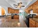 Charming kitchen featuring wood cabinets, granite countertops, and modern appliances at 2761 Phoenix St, Las Vegas, NV 89121