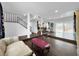 Bright open-concept living room with wood laminate flooring and stair access at 2761 Phoenix St, Las Vegas, NV 89121