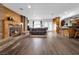 Open living space with brick fireplace, wood floors, and kitchen access at 2761 Phoenix St, Las Vegas, NV 89121