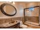 Bathroom features a stand-up shower with glass doors and a decorative vanity with a round mirror at 2845 Red Arrow Dr, Las Vegas, NV 89135