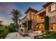 Elegant two-story stone house boasts a rock waterfall feature and multiple balconies at 2845 Red Arrow Dr, Las Vegas, NV 89135