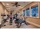 Home gym featuring mirrored wall, a ceiling fan, and a variety of equipment at 2845 Red Arrow Dr, Las Vegas, NV 89135