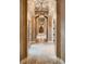 Stunning hallway with arched ceilings, elegant lighting fixtures, and stone flooring leading to various rooms at 2845 Red Arrow Dr, Las Vegas, NV 89135