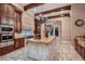 Chef's kitchen with wood beams, custom cabinets, marble countertops, and stainless steel appliances at 2845 Red Arrow Dr, Las Vegas, NV 89135