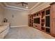Living room features carpeted floors and custom built-in media center with shelving and cabinets at 2845 Red Arrow Dr, Las Vegas, NV 89135