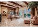 Open living space with beamed ceilings, stone accents, and seamless indoor/outdoor flow at 2845 Red Arrow Dr, Las Vegas, NV 89135
