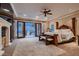 Luxurious primary bedroom with fireplace, balcony access, and ample natural light at 2845 Red Arrow Dr, Las Vegas, NV 89135