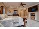 Spacious primary bedroom boasts a fireplace, a TV, and beautiful neutral decor at 2845 Red Arrow Dr, Las Vegas, NV 89135