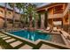 Resort-style pool features a rock waterfall, lounge chairs, and manicured landscaping at 2845 Red Arrow Dr, Las Vegas, NV 89135