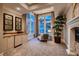 Bright sitting room with a fireplace, wet bar, chandelier, and large windows at 2845 Red Arrow Dr, Las Vegas, NV 89135