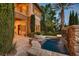 Backyard view of a stone waterfall feature flowing into a small pool with lush greenery at 2845 Red Arrow Dr, Las Vegas, NV 89135