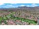 Expansive aerial view showing a golf course community surrounded by lush greenery and well-maintained homes at 3000 Morning Ridge Dr, Las Vegas, NV 89134