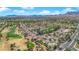 Overhead view of houses next to a beautiful golf course and lush landscapes within a well-planned community at 3000 Morning Ridge Dr, Las Vegas, NV 89134