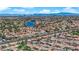 Panoramic aerial view of a residential community featuring beautiful homes and scenic landscaping around a lake at 3000 Morning Ridge Dr, Las Vegas, NV 89134