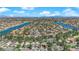 Expansive aerial view showcasing a residential community with water features and stunning mountain and city skyline views at 3000 Morning Ridge Dr, Las Vegas, NV 89134