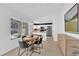 Bright dining area with modern furnishings, and an adjacent kitchen area with stainless steel appliances and plentiful natural light at 3000 Morning Ridge Dr, Las Vegas, NV 89134