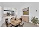 Bright dining area featuring stylish decor, an adjacent kitchen area with stainless steel appliances, and a large picture window at 3000 Morning Ridge Dr, Las Vegas, NV 89134