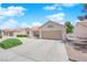 Charming single-story home featuring a well-manicured lawn, neutral paint, tile roof, and an attached two-car garage at 3000 Morning Ridge Dr, Las Vegas, NV 89134