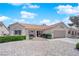 Beautiful single-story home boasts a well-maintained yard, tile roof, neutral paint, and an attached two-car garage at 3000 Morning Ridge Dr, Las Vegas, NV 89134