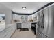 Contemporary kitchen featuring stainless steel appliances, white cabinetry, and tiled floors, with ample natural light at 3000 Morning Ridge Dr, Las Vegas, NV 89134