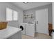 Functional laundry room features new washer and dryer units and a countertop, offering practical laundry convenience at 3000 Morning Ridge Dr, Las Vegas, NV 89134