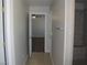Hallway leading to bathroom showcasing tiled shower and neutral color palette at 3020 Peggy Ave, Pahrump, NV 89048